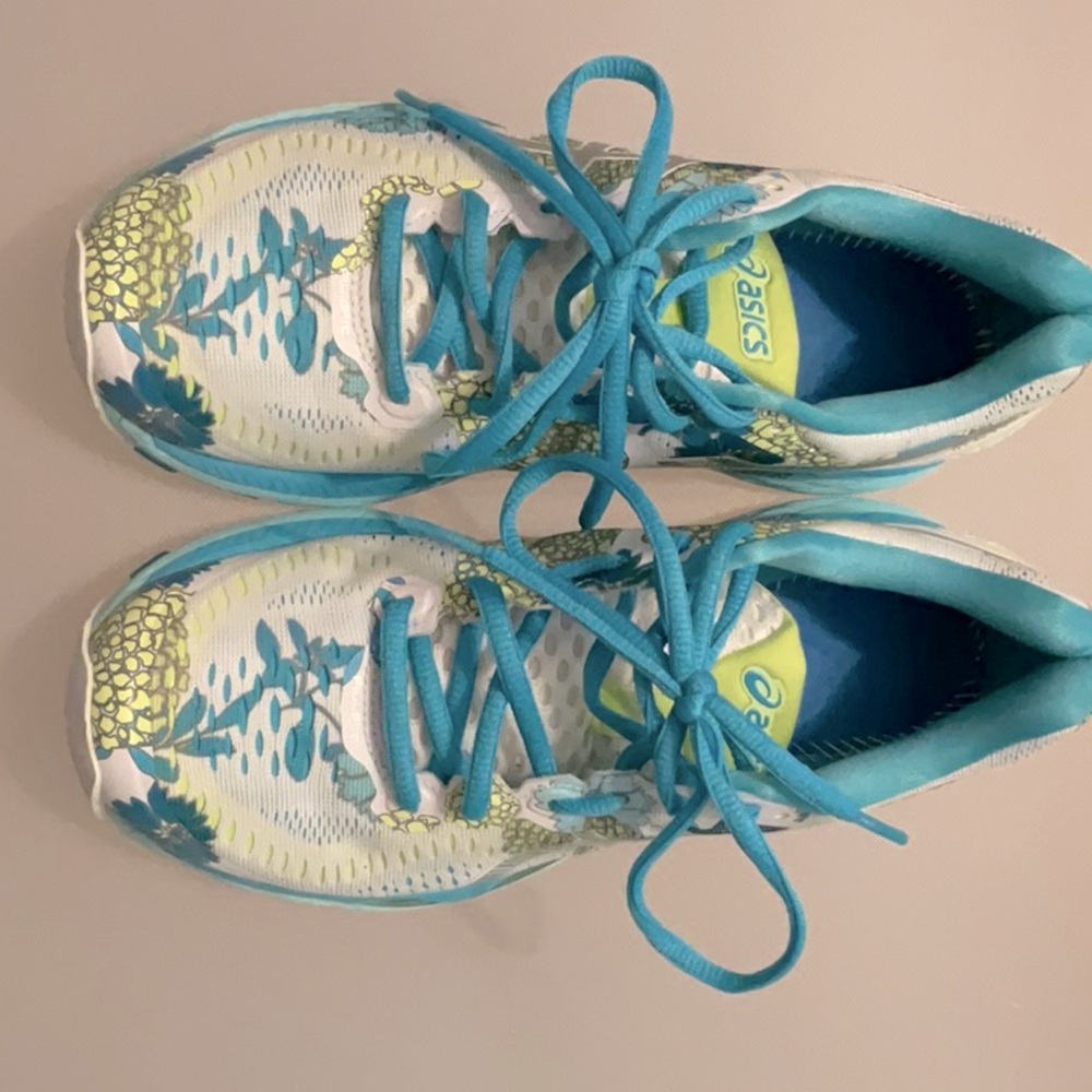 These ASICS sneakers are a size six and used! They are white w/ colorful designs
